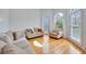 Bright living room featuring hardwood floors, neutral furnishings, and large windows at 370 Beracah Sw Trl, Atlanta, GA 30331