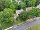 Aerial view of a charming home nestled among mature trees on a well-maintained street at 404 Pine Grove Way, Woodstock, GA 30189