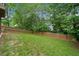 Large backyard featuring a well-maintained lawn and a wooden privacy fence at 404 Pine Grove Way, Woodstock, GA 30189