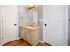 Bathroom features a granite countertop vanity with wood floors, neutral color, and white doors at 404 Pine Grove Way, Woodstock, GA 30189