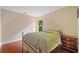 Cozy bedroom with hardwood floors, a window with natural light, and simple furnishings at 404 Pine Grove Way, Woodstock, GA 30189