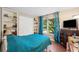 Bedroom with hardwood floors, custom shelving, and a large window with natural light at 404 Pine Grove Way, Woodstock, GA 30189