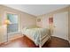 Bright bedroom with hardwood floors, and white trim with a window letting in natural light at 404 Pine Grove Way, Woodstock, GA 30189