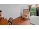Study features hardwood floors, a window with natural light, and a vintage desk at 404 Pine Grove Way, Woodstock, GA 30189