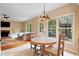 Cozy dining area next to a living room, featuring hardwood floors, natural light, and easy patio access at 404 Pine Grove Way, Woodstock, GA 30189