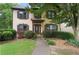 Traditional home featuring a covered front entry, stucco facade, and manicured front yard at 404 Pine Grove Way, Woodstock, GA 30189