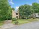 Charming two-story home with mature landscaping, a driveway, and a well-manicured lawn at 404 Pine Grove Way, Woodstock, GA 30189