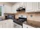 Elegant kitchen showcasing granite countertops, stainless steel appliances, and custom cabinetry at 404 Pine Grove Way, Woodstock, GA 30189