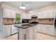 Charming kitchen with white cabinets, granite countertops, stainless steel appliances, and a functional island at 404 Pine Grove Way, Woodstock, GA 30189
