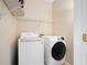 Modern laundry room with new front-load washer and dryer, plus wire shelving at 404 Pine Grove Way, Woodstock, GA 30189