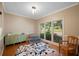 Living room with hardwood flooring and lots of natural light from three large windows at 404 Pine Grove Way, Woodstock, GA 30189