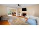 Comfortable living space with a fireplace, hardwood floors, and an adjacent office area at 404 Pine Grove Way, Woodstock, GA 30189