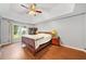 Spacious main bedroom featuring a tray ceiling, wood floors, and natural light at 404 Pine Grove Way, Woodstock, GA 30189