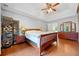 Bright main bedroom showcasing wood floors, a tray ceiling, and an elegant decor at 404 Pine Grove Way, Woodstock, GA 30189