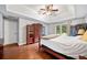 Stylish main bedroom with wood floors, a tray ceiling, and ample closet space at 404 Pine Grove Way, Woodstock, GA 30189