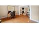 Bright office space featuring hardwood floors, desk setup, and seamless transition to the living room at 404 Pine Grove Way, Woodstock, GA 30189