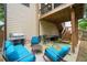 Comfortable patio area with outdoor seating, grill, and stairs to an upper deck at 404 Pine Grove Way, Woodstock, GA 30189