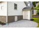 Rear exterior of home featuring white siding, shed/storage, a side door, and gravel landscaping at 124 Richmond Se St, Atlanta, GA 30312