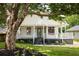 Charming home featuring a welcoming front porch, well-maintained lawn, and beautiful landscaping at 124 Richmond Se St, Atlanta, GA 30312