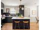 Modern kitchen with island, stylish lighting, quartz countertops, and stainless steel appliances at 124 Richmond Se St, Atlanta, GA 30312