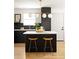 Modern kitchen with island, stylish lighting, quartz countertops, and stainless steel appliances at 124 Richmond Se St, Atlanta, GA 30312