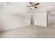 Large bedroom with neutral carpet, ceiling fan, and access to the bathroom at 1307 Aura Ln, Lawrenceville, GA 30045