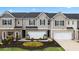 Charming townhomes feature brick accents, attached garages, and landscaped front yards in a desirable community at 1307 Aura Ln, Lawrenceville, GA 30045
