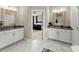 Modern bathroom with double vanity sinks and marble floors leading to the connecting bedroom at 2075 Parkhaven Ct, Roswell, GA 30076