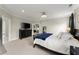 Spacious bedroom featuring neutral walls, plush carpet, and comfortable king bed with a dark blue throw at 2075 Parkhaven Ct, Roswell, GA 30076