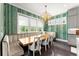 Inviting dining area features a large window and an elegant chandelier at 2075 Parkhaven Ct, Roswell, GA 30076