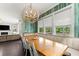 Spacious dining area featuring a long wooden table, large windows, and statement wallpaper at 2075 Parkhaven Ct, Roswell, GA 30076