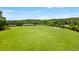 The dog park offers a large fenced-in area for pets to roam and socialize, with seating for owners at 2075 Parkhaven Ct, Roswell, GA 30076