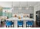 Elegant kitchen with gray cabinets, a large island with blue chairs, and pendant lighting at 2075 Parkhaven Ct, Roswell, GA 30076