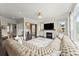 Open concept living room with a plush sectional, fireplace, and elegant chandelier at 2075 Parkhaven Ct, Roswell, GA 30076