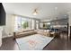 Open-concept living space with large windows, plush sectional, and gourmet kitchen in view at 2075 Parkhaven Ct, Roswell, GA 30076