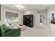 A cozy living room area with carpet, an entertainment center, and natural lighting at 2075 Parkhaven Ct, Roswell, GA 30076