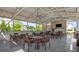 Relax in the spacious outdoor seating area with multiple tables, a fireplace, and a ceiling fan at 2075 Parkhaven Ct, Roswell, GA 30076