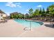 Enjoy the community pool with lounge chairs and meticulously-maintained landscaping on a sunny day at 2075 Parkhaven Ct, Roswell, GA 30076