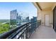 Modern balcony view showcasing surrounding greenery and a sleek, reflective building at 3445 Stratford Ne Rd # 2703, Atlanta, GA 30326