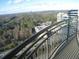 Enjoy panoramic city and nature views from this condo's private balcony with modern railing at 3445 Stratford Ne Rd # 2703, Atlanta, GA 30326