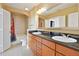 Bathroom with double sink vanity, black granite countertops, and shower-tub combo at 3445 Stratford Ne Rd # 2703, Atlanta, GA 30326