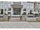Elegant building entrance with stone steps, lush planters, and clear signage at 3445 Stratford Ne Rd # 2703, Atlanta, GA 30326