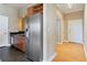 Spacious kitchen with stainless steel refrigerator, dark countertop, and wooden floors at 3445 Stratford Ne Rd # 2703, Atlanta, GA 30326