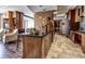 Modern kitchen featuring dark countertops, wood cabinetry, and an island with seating at 3445 Stratford Ne Rd # 2703, Atlanta, GA 30326
