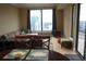 Open-concept living space featuring dining table, sofa and outdoor views at 3445 Stratford Ne Rd # 2703, Atlanta, GA 30326
