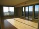Sun-filled living room with large windows, hardwood floors, and a balcony at 3445 Stratford Ne Rd # 2703, Atlanta, GA 30326