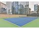 Well-maintained tennis court with city skyline in the background at 3445 Stratford Ne Rd # 2703, Atlanta, GA 30326