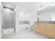 A well-lit bathroom includes granite counters, tub and shower, with tile flooring at 361 17Th Nw St # 1702, Atlanta, GA 30363