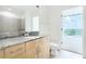 A stylish bathroom includes a granite counter, wood cabinets, mirror and toilet at 361 17Th Nw St # 1702, Atlanta, GA 30363