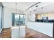 Modern kitchen features a breakfast bar, stainless steel appliances, and beautiful city views from the large windows at 361 17Th Nw St # 1702, Atlanta, GA 30363